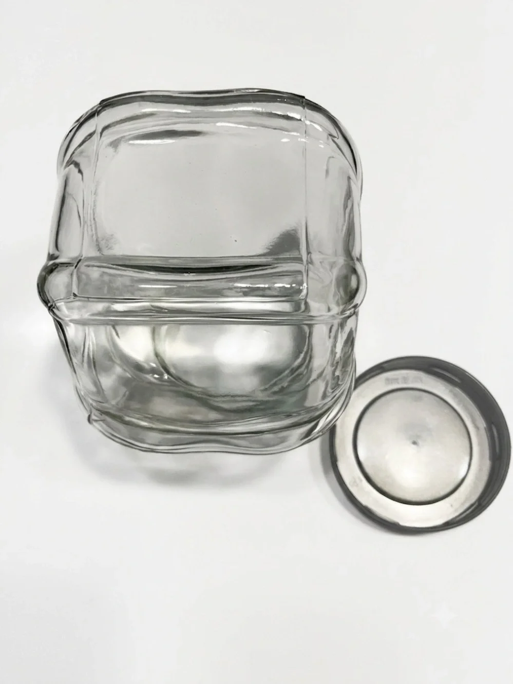 Ikea Förvar glass canister featuring a distinctive hexagonal shape & a gray lid.